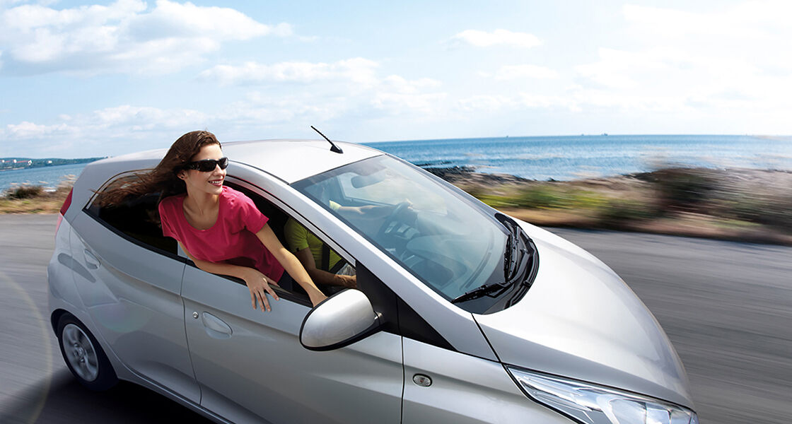 A woman on the passenger's seat enjoying driving moment