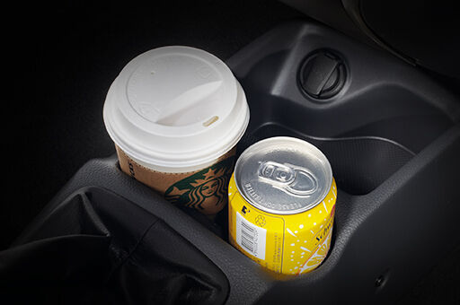 Drink can and cup stored in the floor console storage