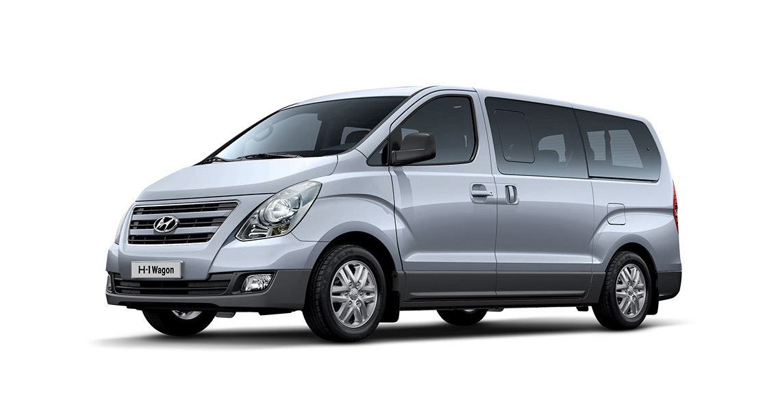 Right front view of a silver van with black back ground