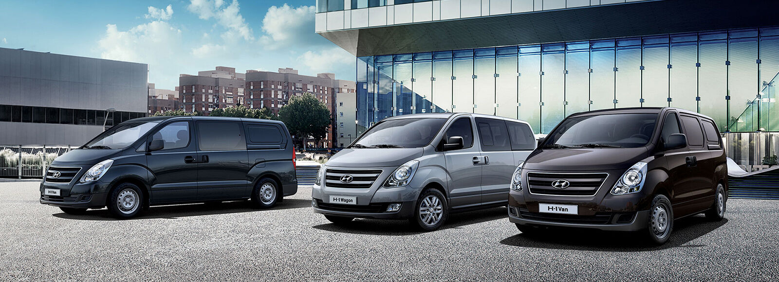 Front view of navy, gray and brown van's near a building