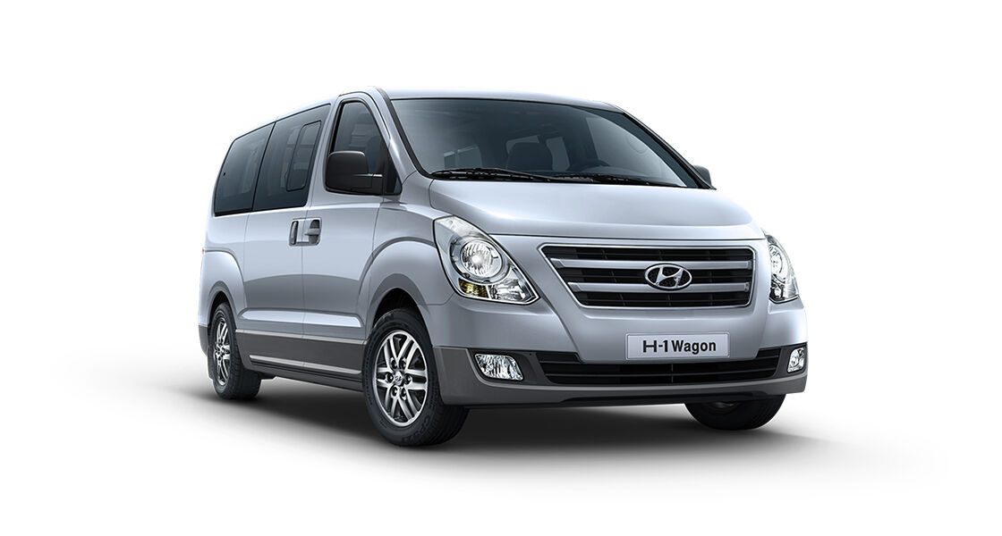 Right front view of a silver van with black back ground