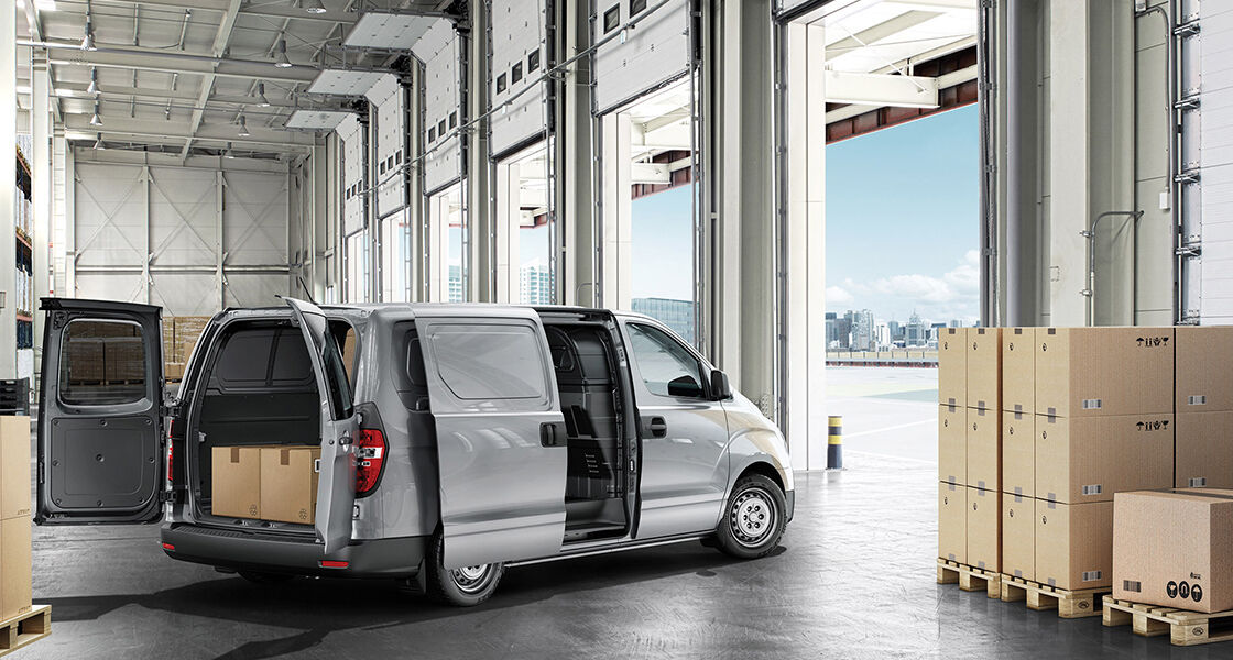A right rear view of gray H-1 with door open in the building