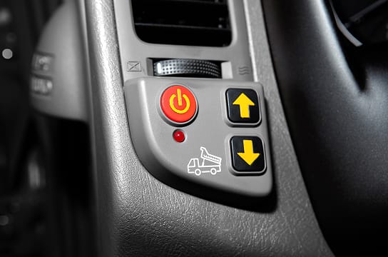 Close-up photo of the dump bed control switch inside the vehicle