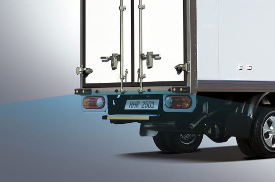 Studio close-up photo of the parking assist sensor at the rear of the vehicle in operation