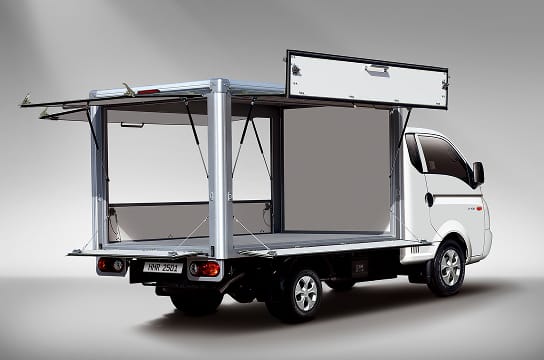 Studio image of a multi-purpose truck with 2 out of 3 opening doors