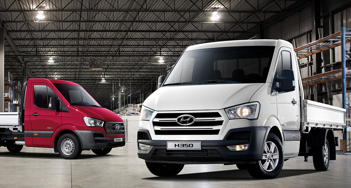 White H350 in front and red h350 parked behind indoor