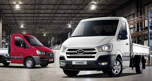 White H350 in front and red h350 parked behind indoor