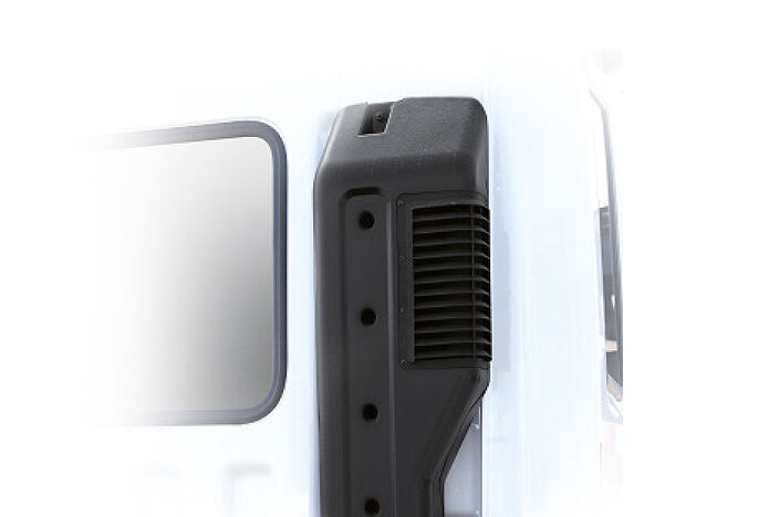 a black air intake duct behind of cab