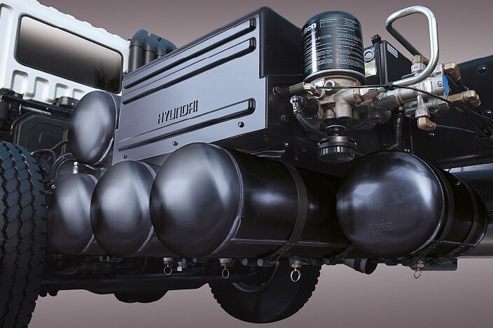 several black cylindrical air tanks behind of trucks cab