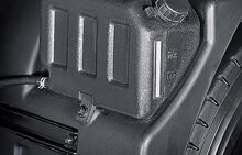 black radiator reservoir box mounted to the inside of fender