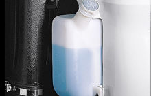 The blue washer fluid is contained in a white plastic bottle