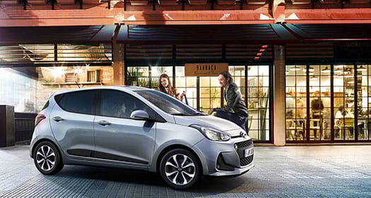 Side view of silver i10 parked outdoor at night