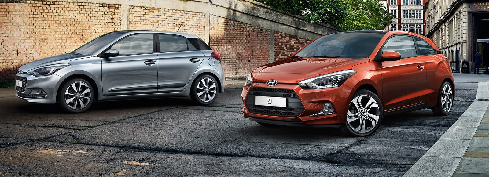 Side view of two i20 Coupe parked on the street