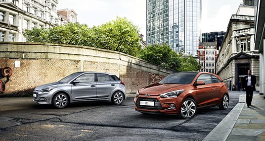 Side view of two i20 coupe on the street