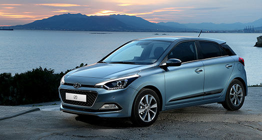 Left side front view of skyblue i20 parked on the road with the river beside