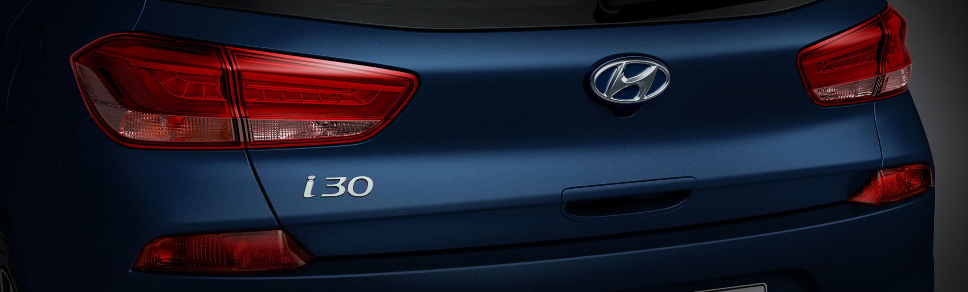 Closer view of left side rear view of blue i30 on the road