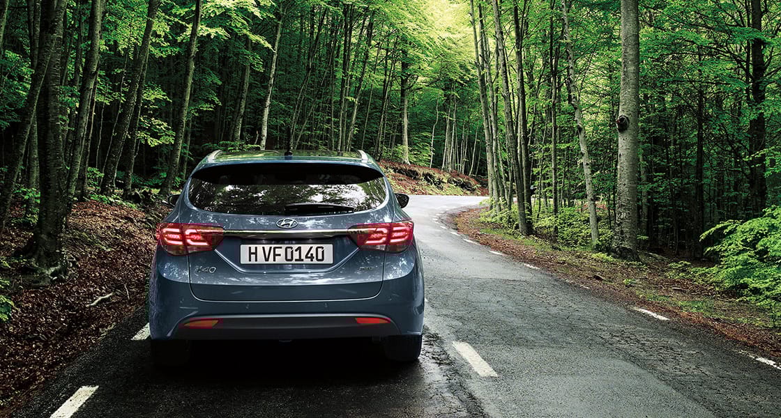 Rear view of dark gray i40 in the forest