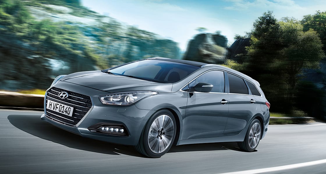 Side front view of dark gray i40 driving on the road