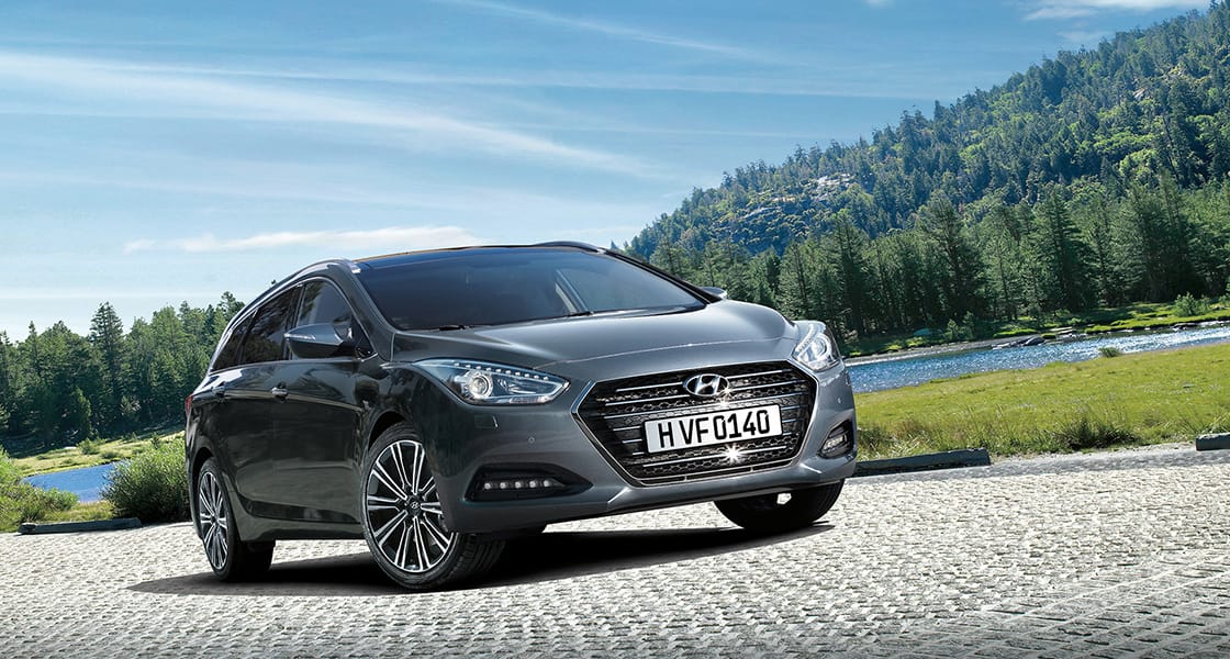 Side front view of dark gray i40 parked lakeside