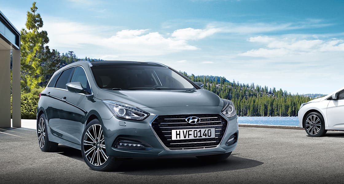 Side front view of dark gray i40 parked lakeside