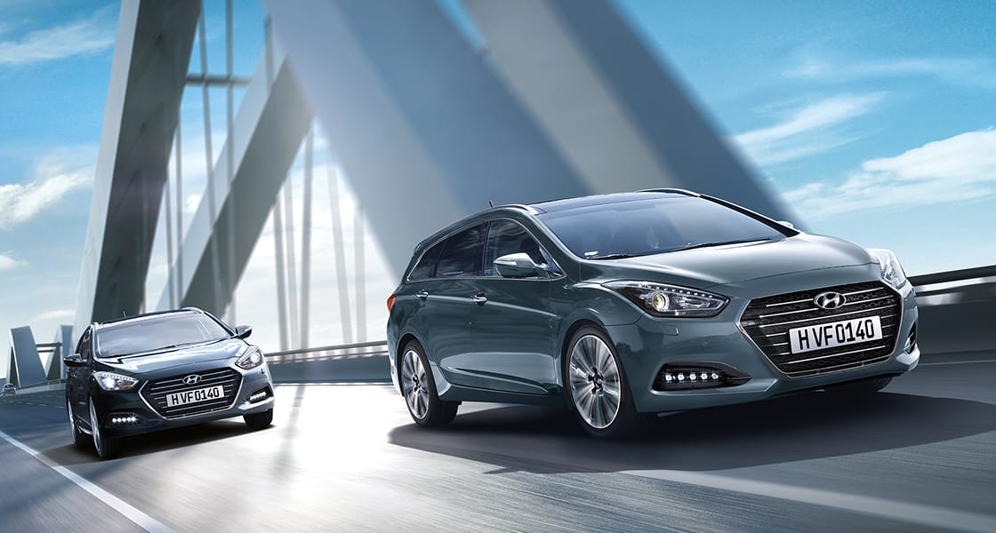 Two dark gray i40 driving in line on the bridge