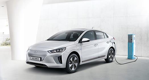 Side front view of Ioniq electric getting charged