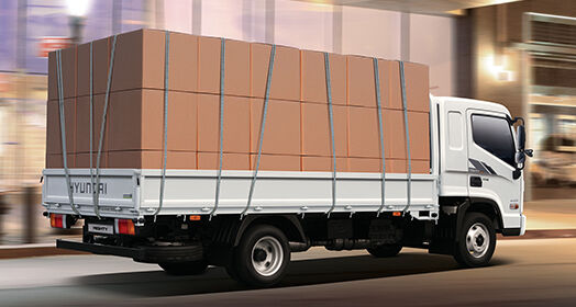 Side view of Mighty with many boxes loaded on the bed