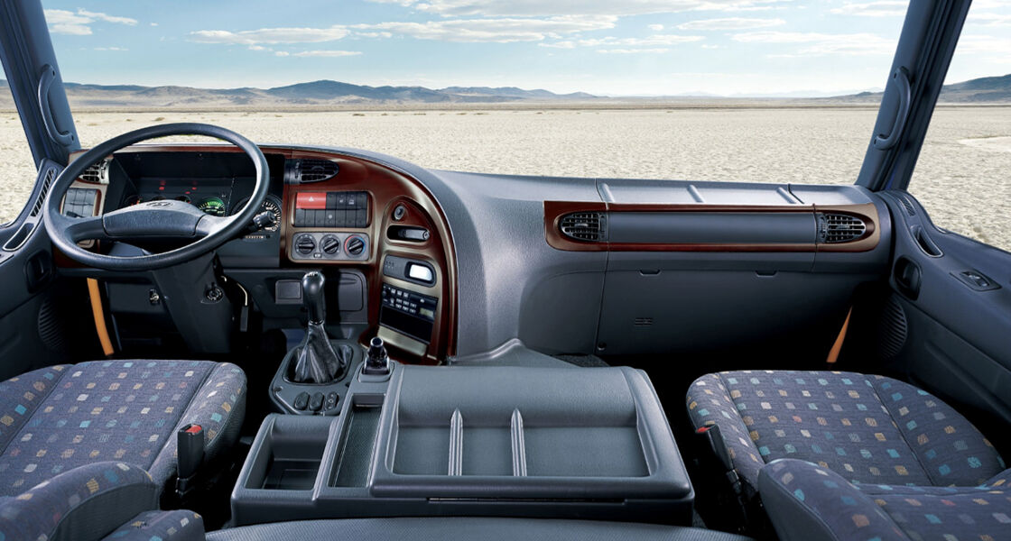 inside of truck's cockpit with wide dessert view