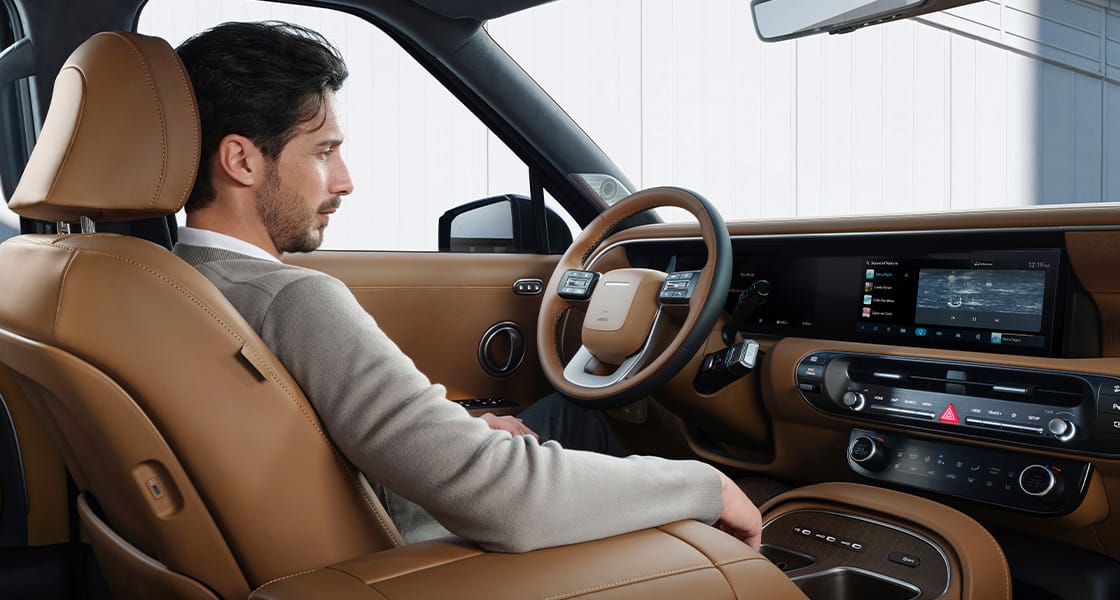 A man stting in the driver's seat inside the all-new PALISADE