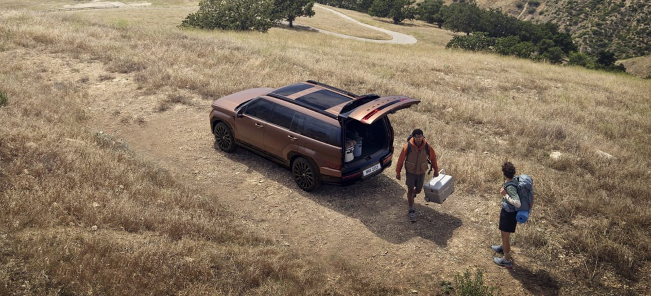 Campers unloading gear through the Santa Fe tailgate