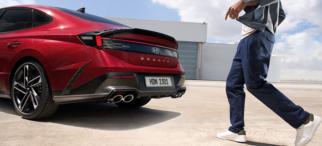 Image of a person approaching the back of the red The new SONATA
