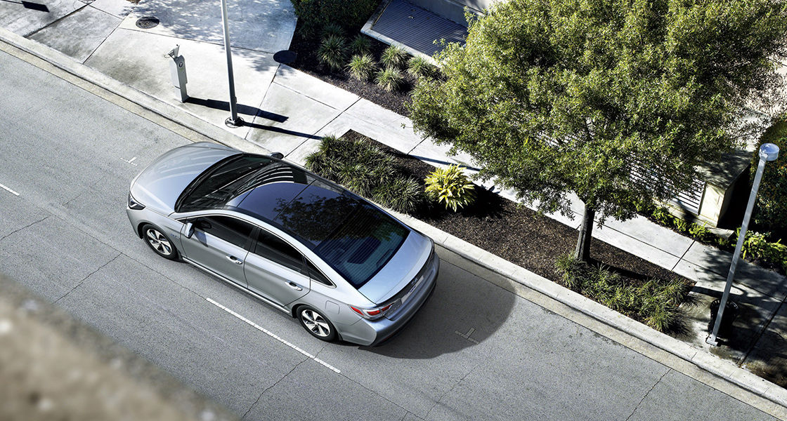 Sky view of gray Sonata Hybrid driving in the city