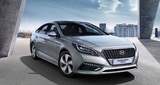 Right side front view of silver Sonata hybrid parked on the road
