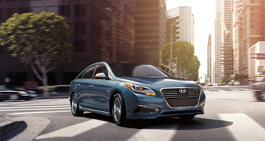 Side front view of Sonata Plug-in Hybrid driving the corner of the city
