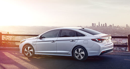 Side view of white Sonata Plug-in Hybrid parked in the evening