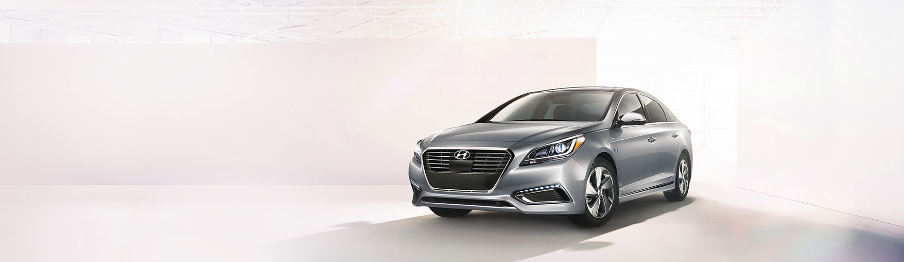 Gray color Sonata Hybrid is placed in front of bright geometrical background