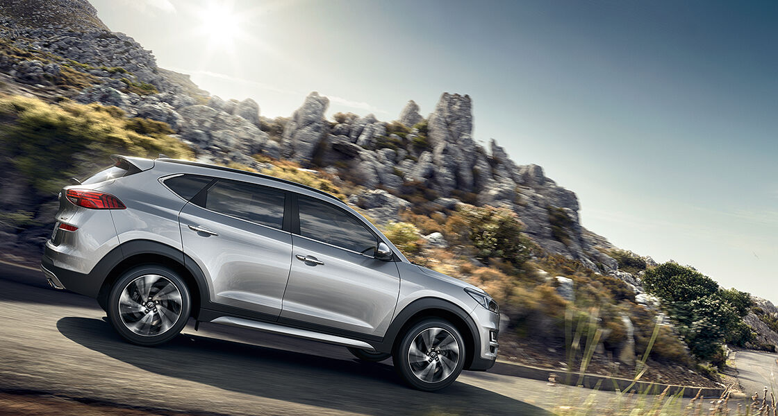 Side view of gray Tucson with aerodynamic graphic surrounding 