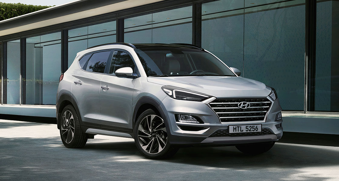 Side front view of blue Tucson