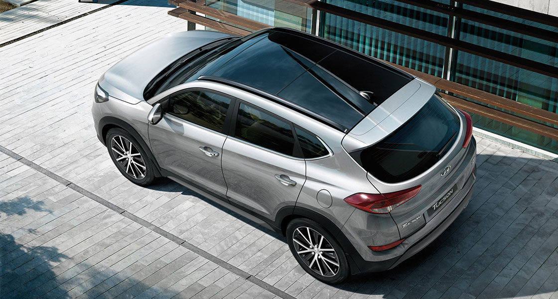 Sky view of silver Tucson from left side rear viewpoint