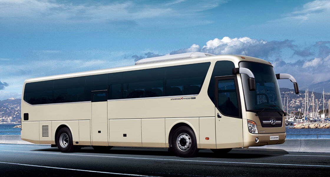 the universe bus is standing in the middle of city