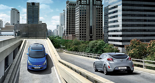 Blue veloster driving down from the high-level road while gray veloster passing by