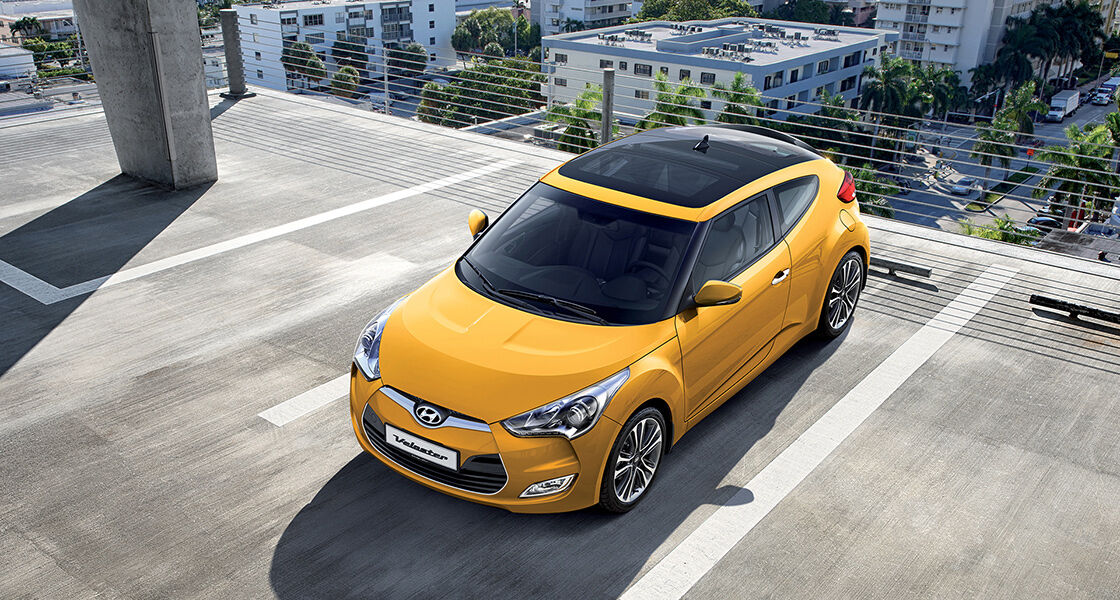 Sky view of yellow veloster parked on the roof of the building