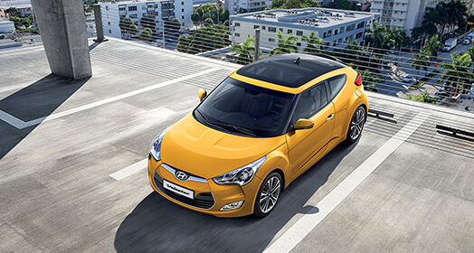 Sky view of yellow veloster parked on the roof of the building