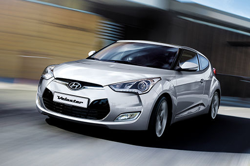 Front view of silver Veloster driving on the road