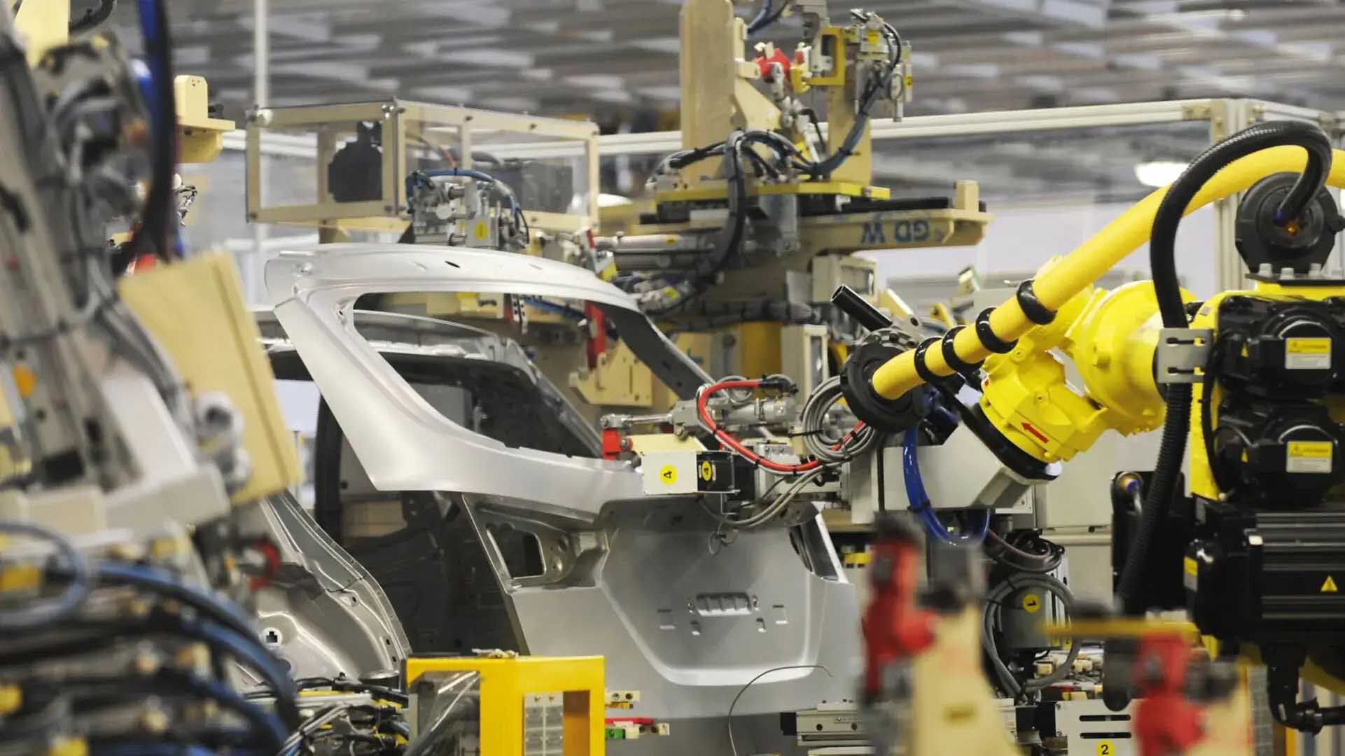 Robotic arms at work in a Hyundai manufacturing facility.