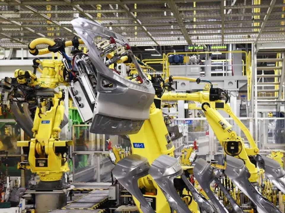 Robotic arms at work in a Hyundai manufacturing facility.