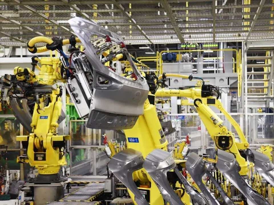 Robotic arms at work in a Hyundai manufacturing facility.