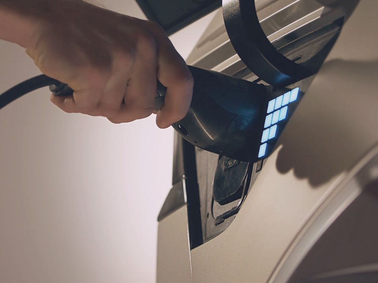  A close up of the Hyundai IONIQ 5 being plugged in for charging.