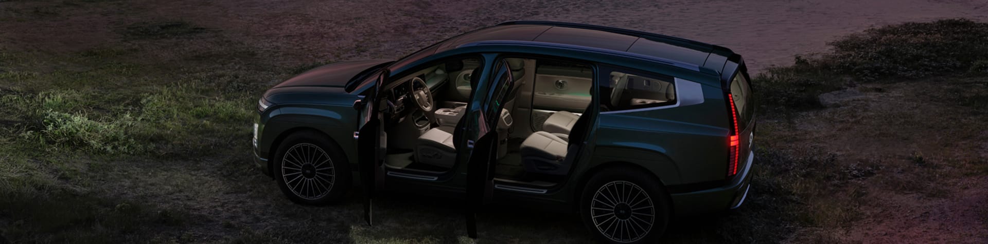 A parked Hyundai IONIQ 9 with all doors open, revealing its spacious and inviting interior