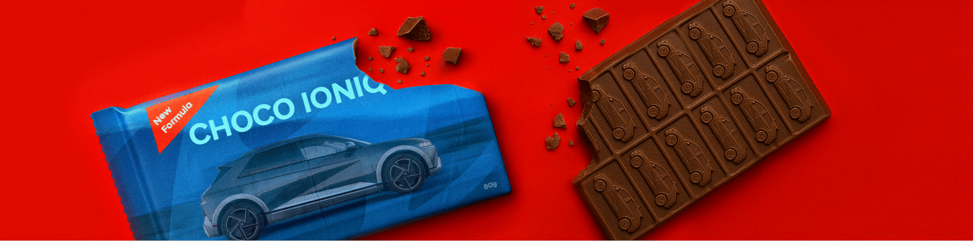 A chocolate bar and an open wrapper, both featuring the image of a Hyundai IONIQ 5 printed on them.